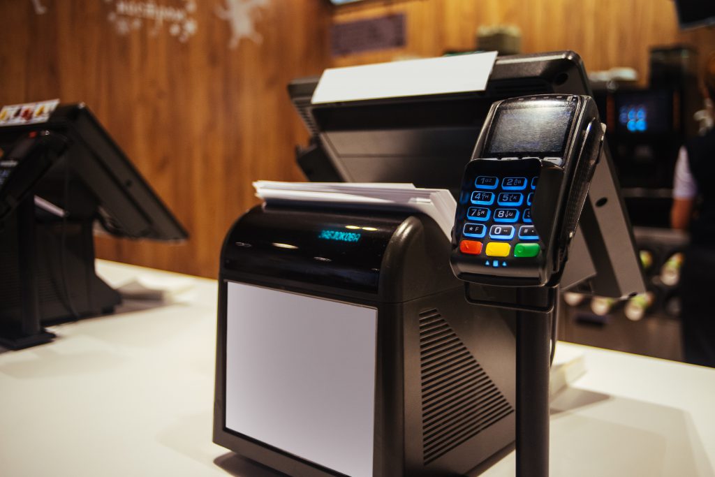 Poin of sell terminal with touchless technology and cashbox on background