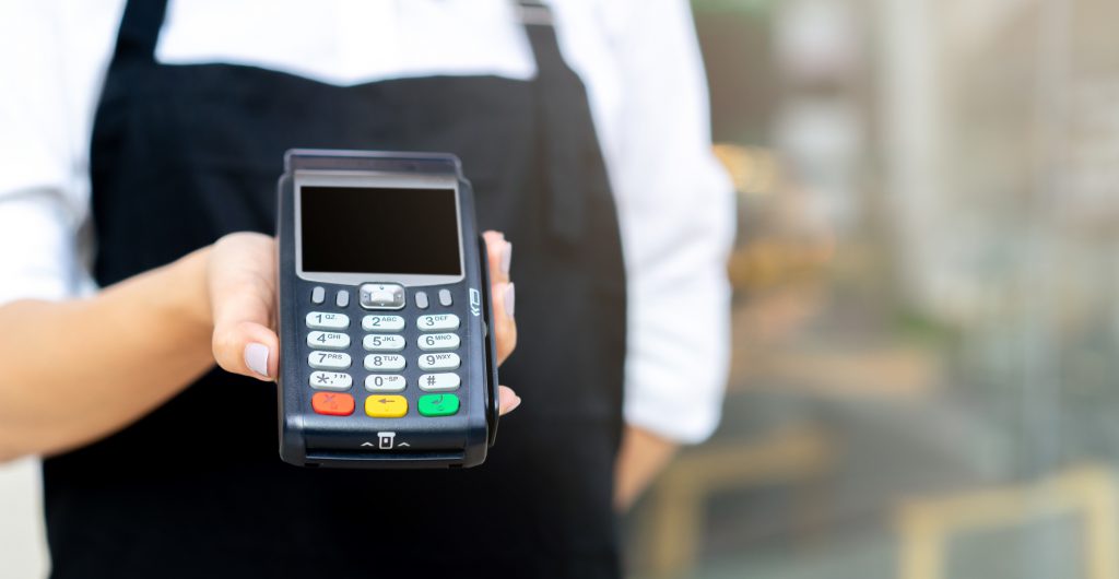 close up waitress worker hand showing an electronic banking money machine for receiving purchase from customer outside the restaurant shop , business and technology of contactless payment concept (the screen isolated with clipping path) ERP system in Singapore, POS, Multiable