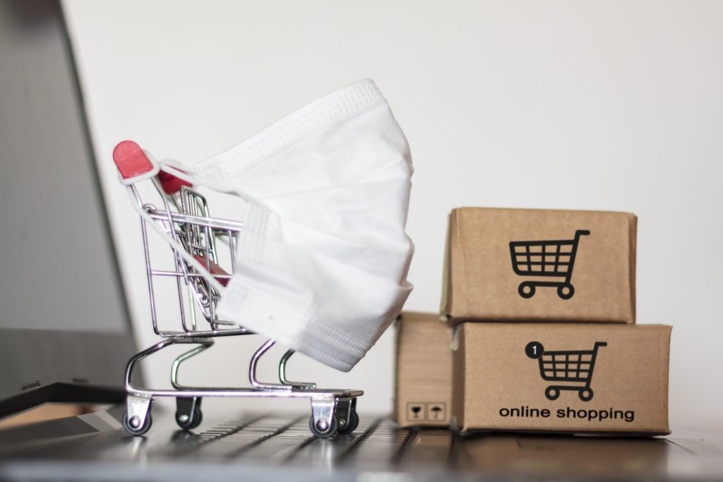 Shopping cart and carton boxes on laptop Our Traditional Sales Methods are Working Well Enough Now. How Necessary is e-commerce?