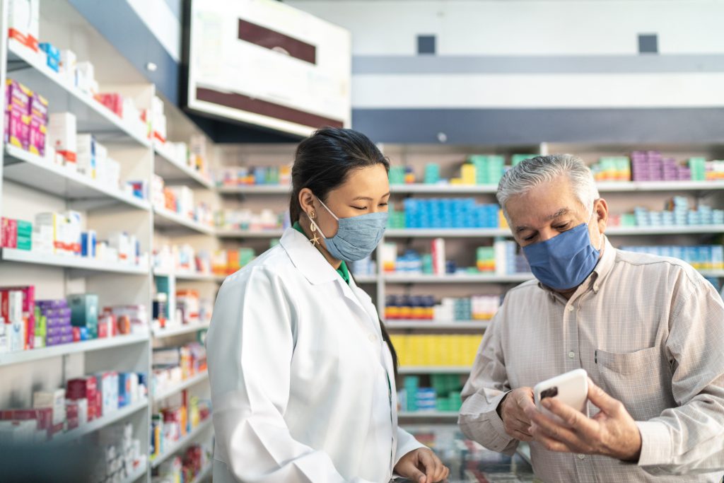 Female pharmacist helping a senior customer Female pharmacist helping a senior customer, How ERP System benefits Pharmaceutical Distributors?