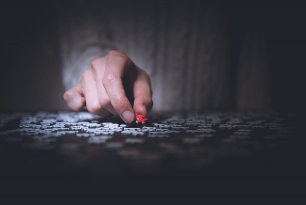 Red puzzle, MES and ERP Integration in Singapore Hand pick up a red puzzle, ERP system solution in Singapore